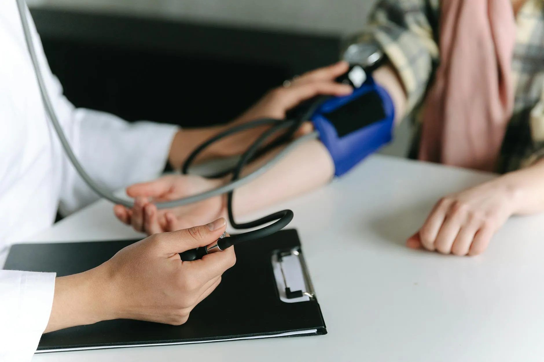 Healthcare worker measuring a patient’s blood pressure