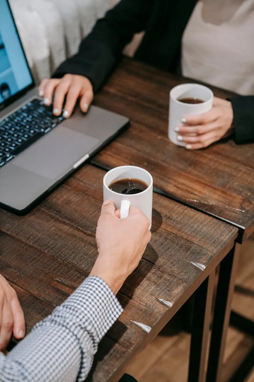 Two colleagues discussing over coffee